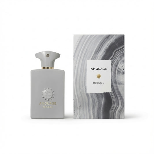 Amouage Decision fragrance bottle in a matte light gray finish with a gold-toned collar and matching cap, standing next to its packaging box which features a gray and white marbled pattern and a white label.