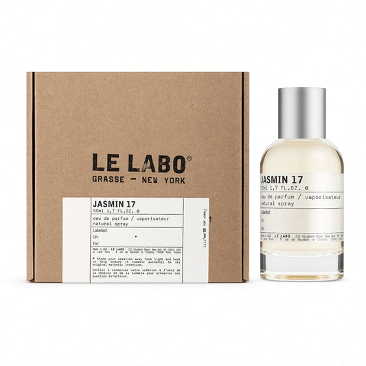 Le Labo Jasmin 17 natural spray perfume bottle next to its brown kraft paper packaging box on a white background.
