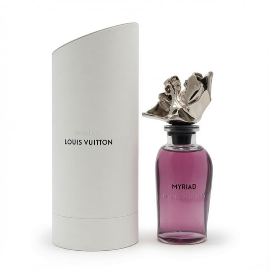 Louis Vuitton Myriad perfume bottle with a metallic silver cherub cap next to its white cylindrical packaging box on a white background.